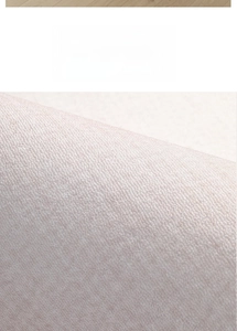 Macro shot of the soft short plush texture on the beige round office chair floor mat