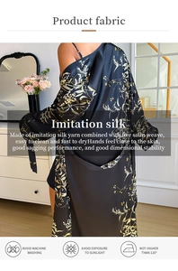 Detail of floral black faux silk robe fabric showing the satin texture and wash care symbols