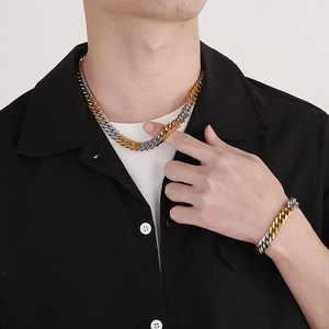 Two-tone gold and silver Cuban link necklace and bracelet set displayed on a model