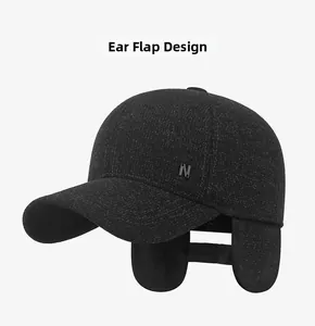 Detail view of winter baseball cap with earflaps unfolded and metal N letter ornament