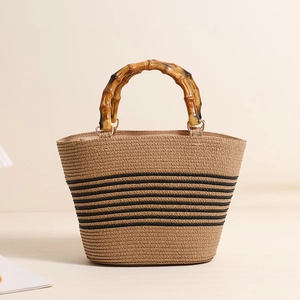 Straw handbag with natural bamboo handle and black stripes for summer beach vacation