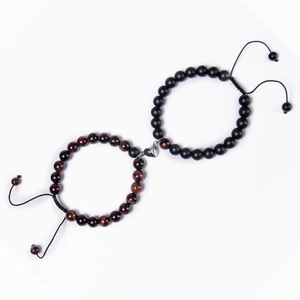 Detail of couple bracelets with magnetic heart clasp and adjustable natural stone beads