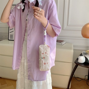 Detailed view of quilted embroidery rabbit pencil case with a purple woven handle