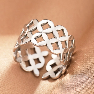 Macro shot of wide open ring featuring geometric hollow lattice pattern on satin