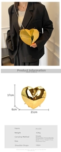 Detail view of heart-shaped acrylic clutch bag with golden chain strap and dimensions