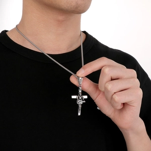 Detail of silver skull guitar cross pendant on men's stainless steel necklace