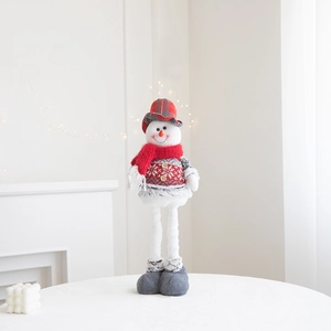 Detail of cute Christmas snowman plush doll with long legs and cozy knit sweater
