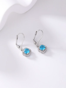 Macro shot of silver sky blue zircon earrings with sparkling micro-pave accents