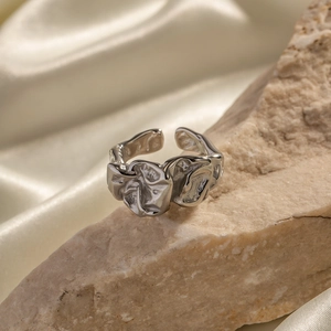 Adjustable silver stainless steel lava ring with irregular textured metal surface