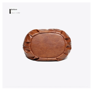 Detailed bottom view showing the pleated texture and base of the brown leather tote bag