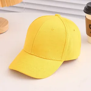 Detail of a bright yellow cotton baseball cap with six-panel structure and curved brim
