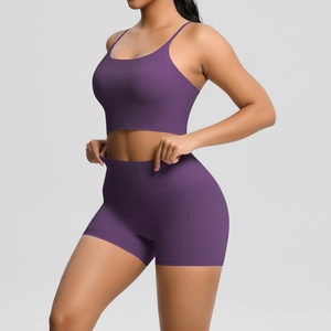 Detail of high-waist seamless dark purple yoga set with sports bra and gym shorts