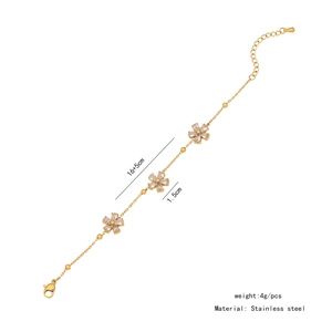 Detail of gold stainless steel bracelet featuring three zircon flower charms and lobster clasp