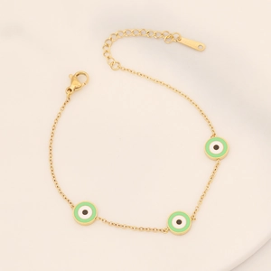 Gold stainless steel evil eye bracelet featuring green enamel charms on thin chain