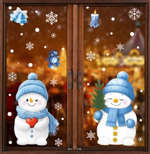 Close-up of cute snowman window stickers with snowflake and bell decals on glass