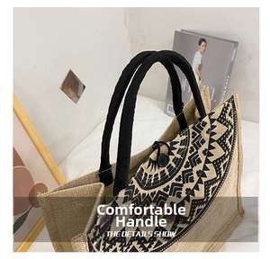 Close-up of ethnic jute tote bag with black geometric patterns and rope handles