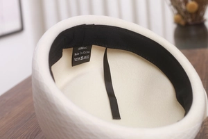 Detail of pure wool beret interior with black sweatband and adjustable drawstring