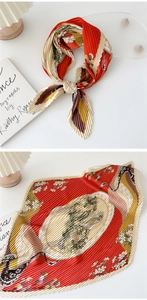 Detail of red and yellow pleated silk scarf featuring artistic floral prints and organza folds