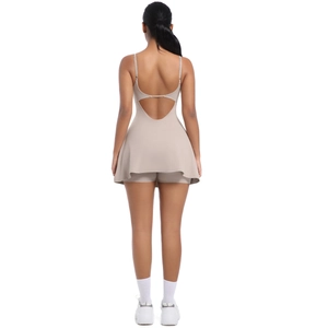 Detail of cross-back straps and open back design on beige athletic tennis dress