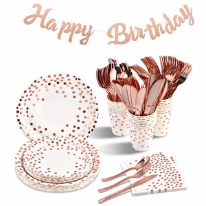 Detailed rose gold polka dot party tableware set including plates, cups, and napkins