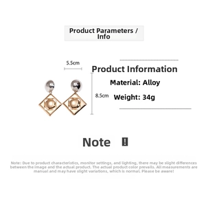 Detail of geometric silver ball and golden square drop earrings showing 8.5x5.5cm size
