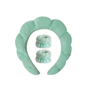 Detailed view of mint green plush spa headband and matching absorbent wrist washbands