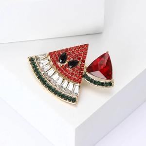 Chic watermelon brooch with red and green rhinestones on a white geometric background