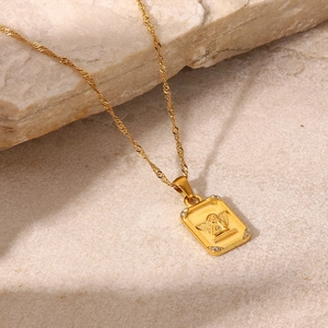 Detail of 18K gold stainless steel angel pendant necklace with set cubic zirconia stones