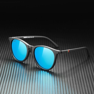 Close-up of matte black polarized sunglasses with blue mirrored lens and striped temple detail