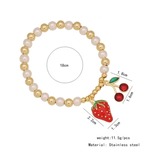 Detail view of strawberry and cherry charms with size measurements and pearl beads