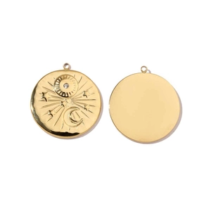 Close-up of gold stainless steel celestial sun and moon charm pendants with a small crystal