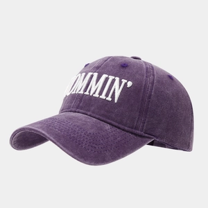 Detail of MOMMIN white embroidery on vintage washed purple cotton baseball cap fabric