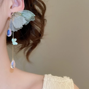 Detailed close-up of butterfly wings and long golden tassels with iridescent teardrop beads