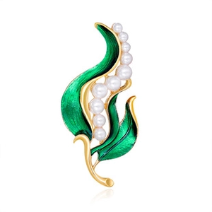 Detailed view of lily of the valley brooch with green enamel leaves and white pearls