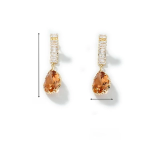 Detail shot of amber teardrop earrings showing 4.8cm length and crystal gold metalwork