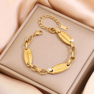 Elegant gold-plated stainless steel pig nose link chain bracelet on pink silk background