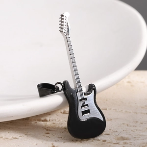Detailed macro view of a 52mm guitar pendant in two-tone black and silver stainless steel