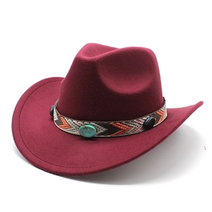 Detail of burgundy felt cowboy hat featuring a colorful ethnic woven band and turquoise studs