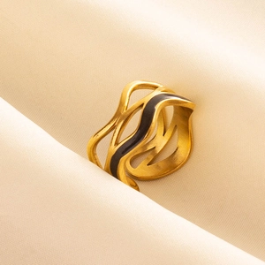Golden wave ring with black enamel accent on premium beige silk fabric background