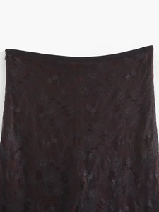 Detail shot of black lace overlay waist with hidden side zipper and floral pattern