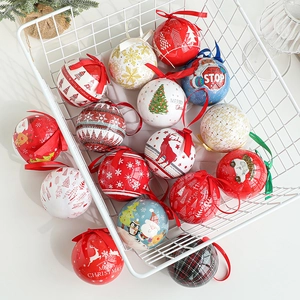 Set of colorful tin Christmas ornaments with festive patterns in a white metal basket