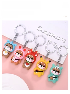 Detailed view of five cartoon Shiba Inu keychains wearing animal-themed costumes