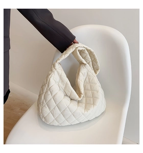 Detail view of the soft quilted fabric texture on the white cloud shaped crossbody bag