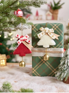 Detail of red felt and white plush Christmas tree ornaments with golden bells and bows