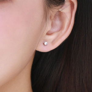 Minimalist S925 sterling silver moissanite stud earring worn on a model's earlobe