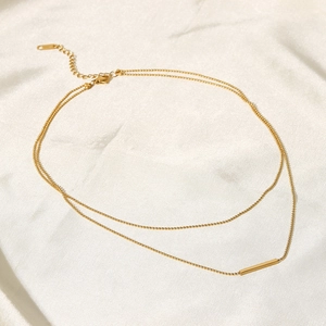 Double layered gold T-bar pendant necklace on white silk fabric for women's fashion