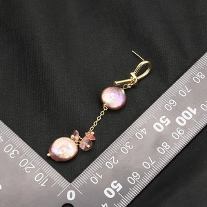 Baroque pink pearl drop earrings with 18k gold plating shown against a measuring scale