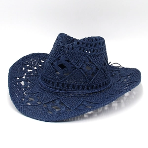 Macro view of navy blue hand-woven cowboy straw hat with breathable cutout patterns