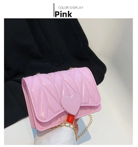 Detailed view of pink silicone heart-shaped mini bag with golden chain strap