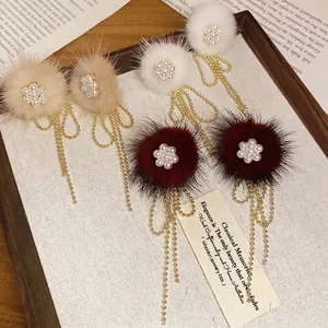 Elegant pearl floral earrings with faux fur pom poms and long gold bead tassels